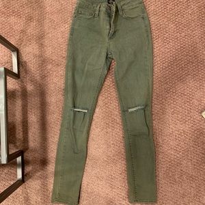 Olive green skinny jeans with rips